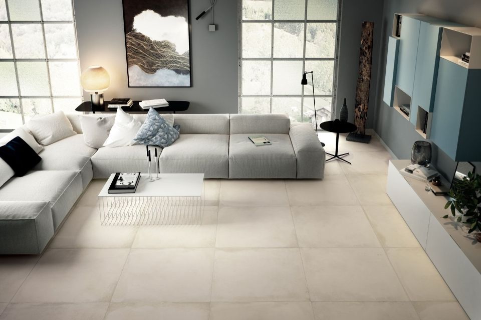 Borigni by Emser oversized tile in a modern living space with large white sectional sofa